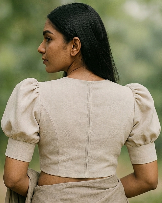 Puff‑sleeve blouse with structured rounded sleeves, soft volume at the shoulders, fitted bodice, back